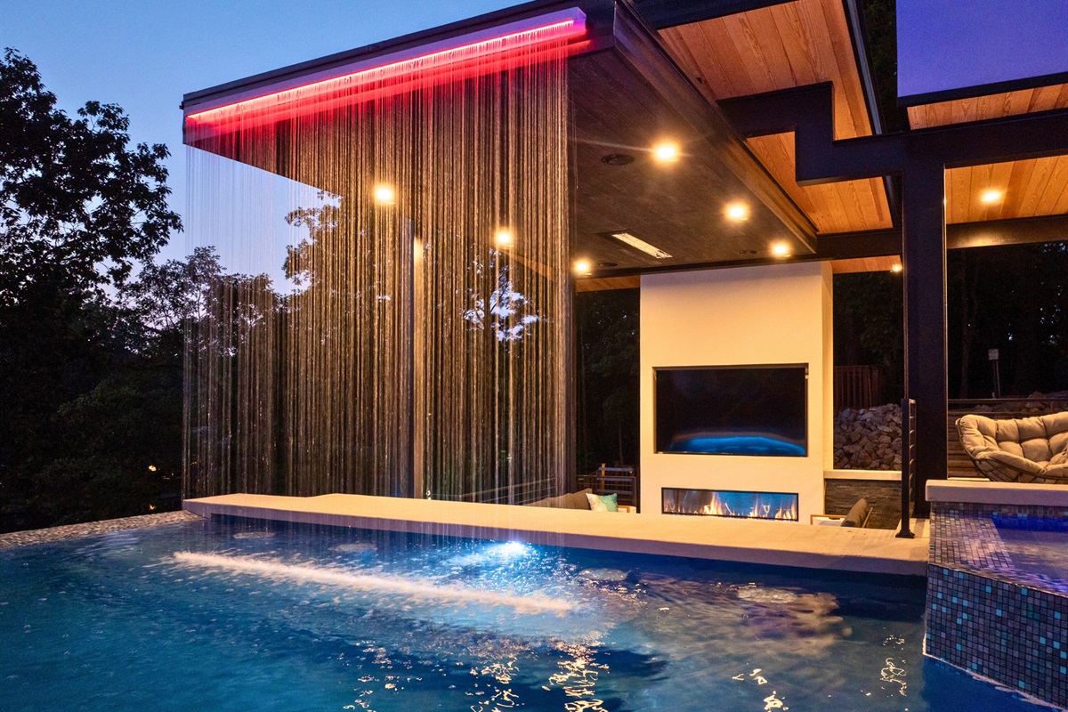 Enjoy the best of outdoor living with the poolside bar and its stunning waterfall backdrop, perfect for any occasion.