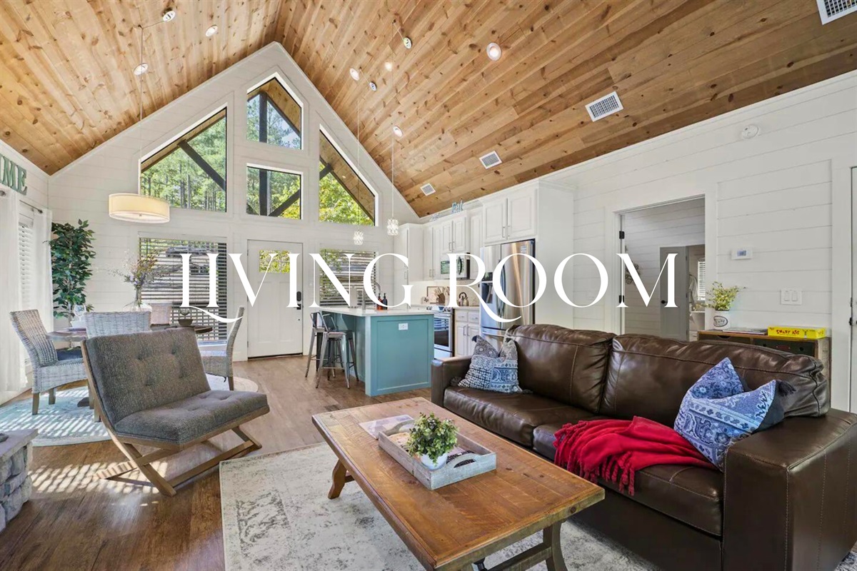 Cozy up by the fireplace in our spacious living room, where comfort and style create a relaxing environment.