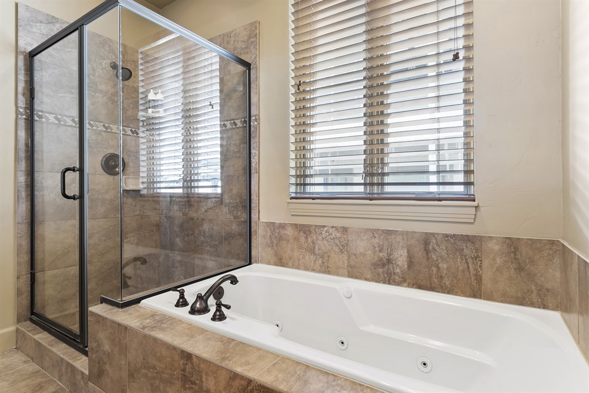 Relax and unwind in the soaking tub or step into the glass shower—your own private spa-like escape.
