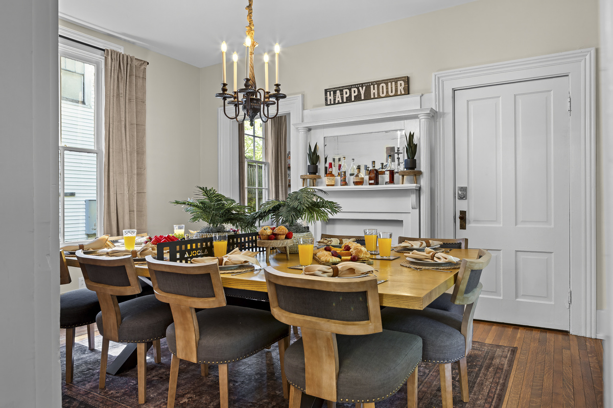 Gather the whole group around the long dining table, where the “Happy Hour” sign above the fireplace sets the perfect tone for shared meals and conversation.