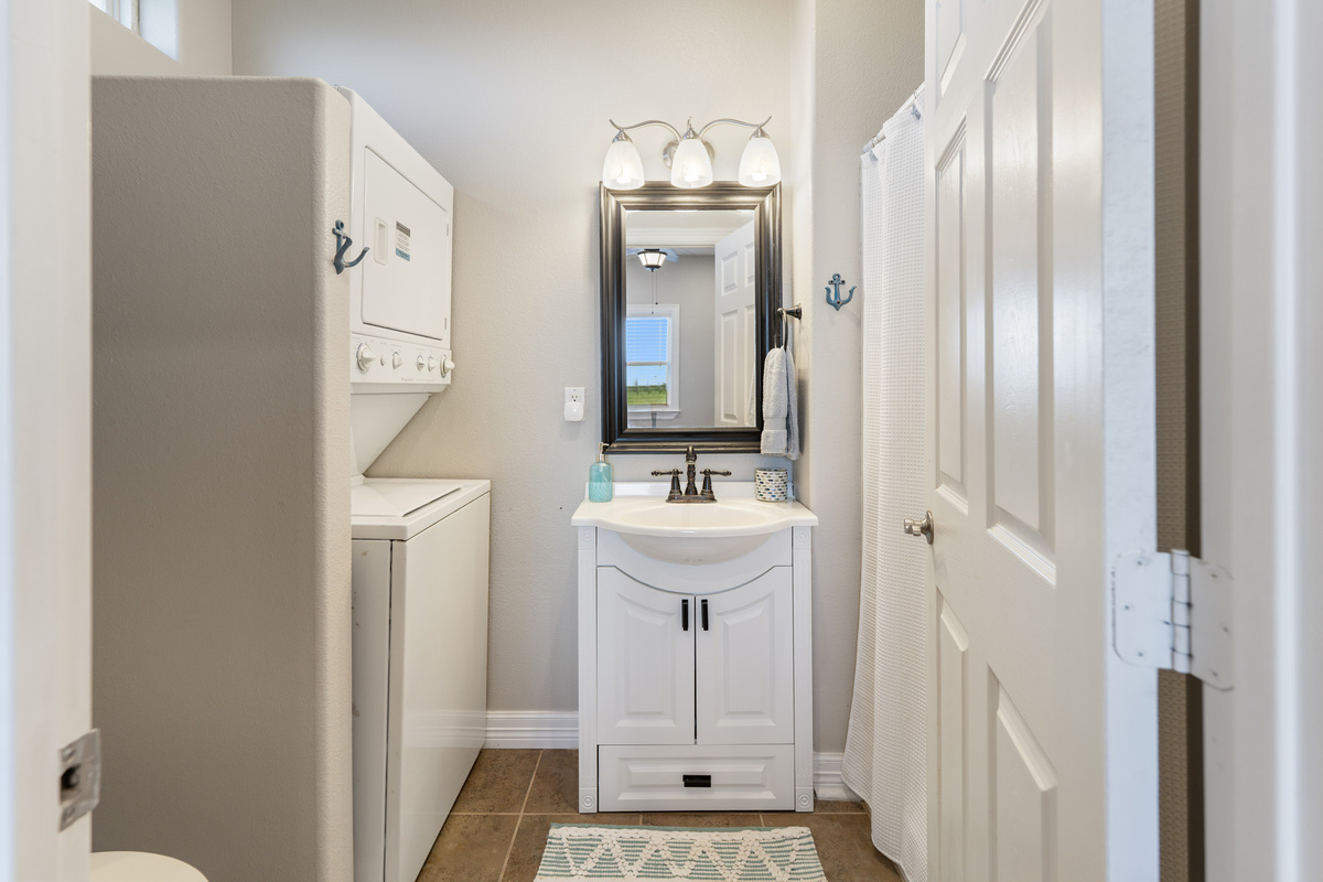 Primary bathroom with washer and dryer.