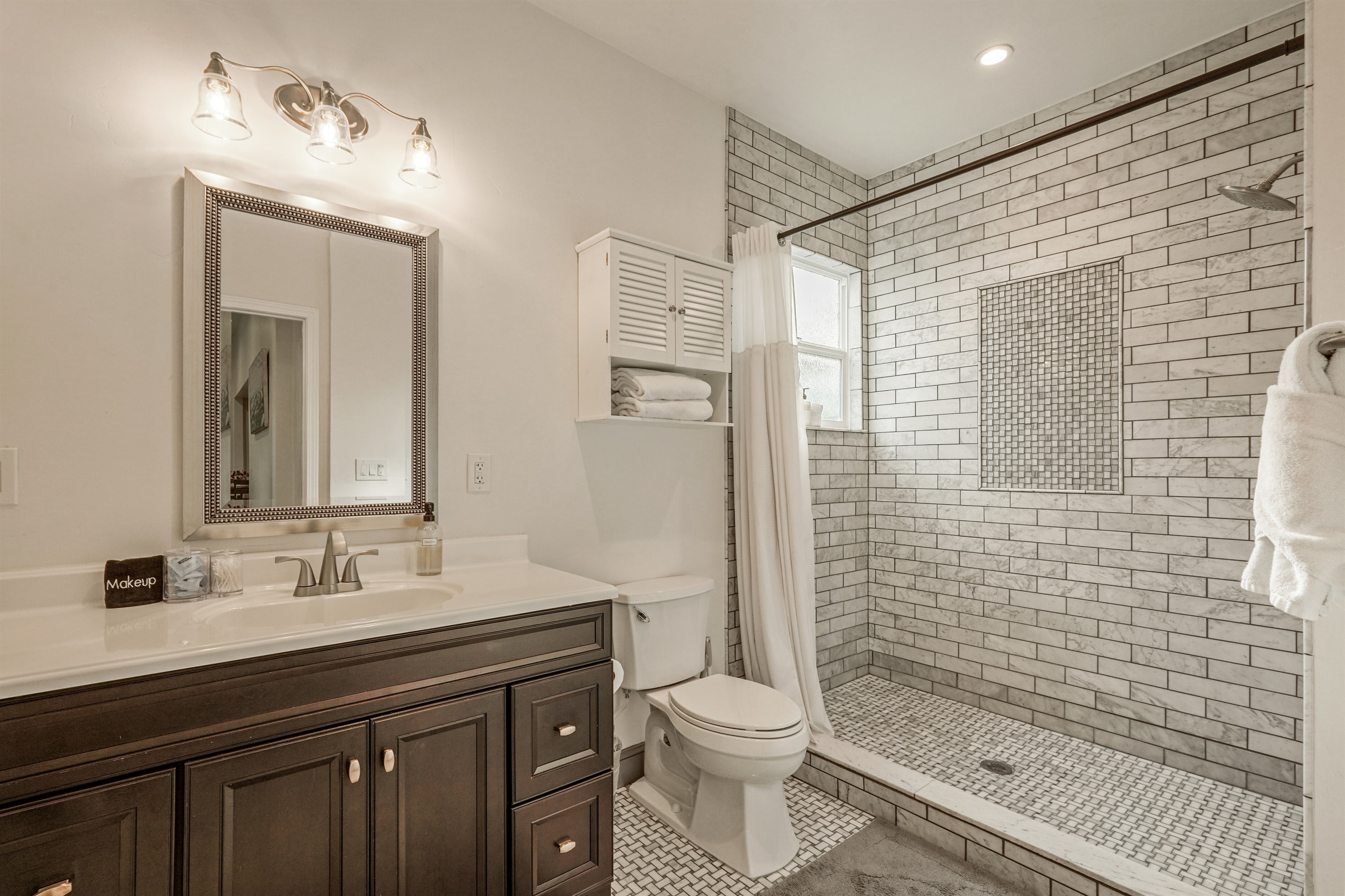 The first of two bathrooms has a large step-in shower and is situated between the two bedrooms.