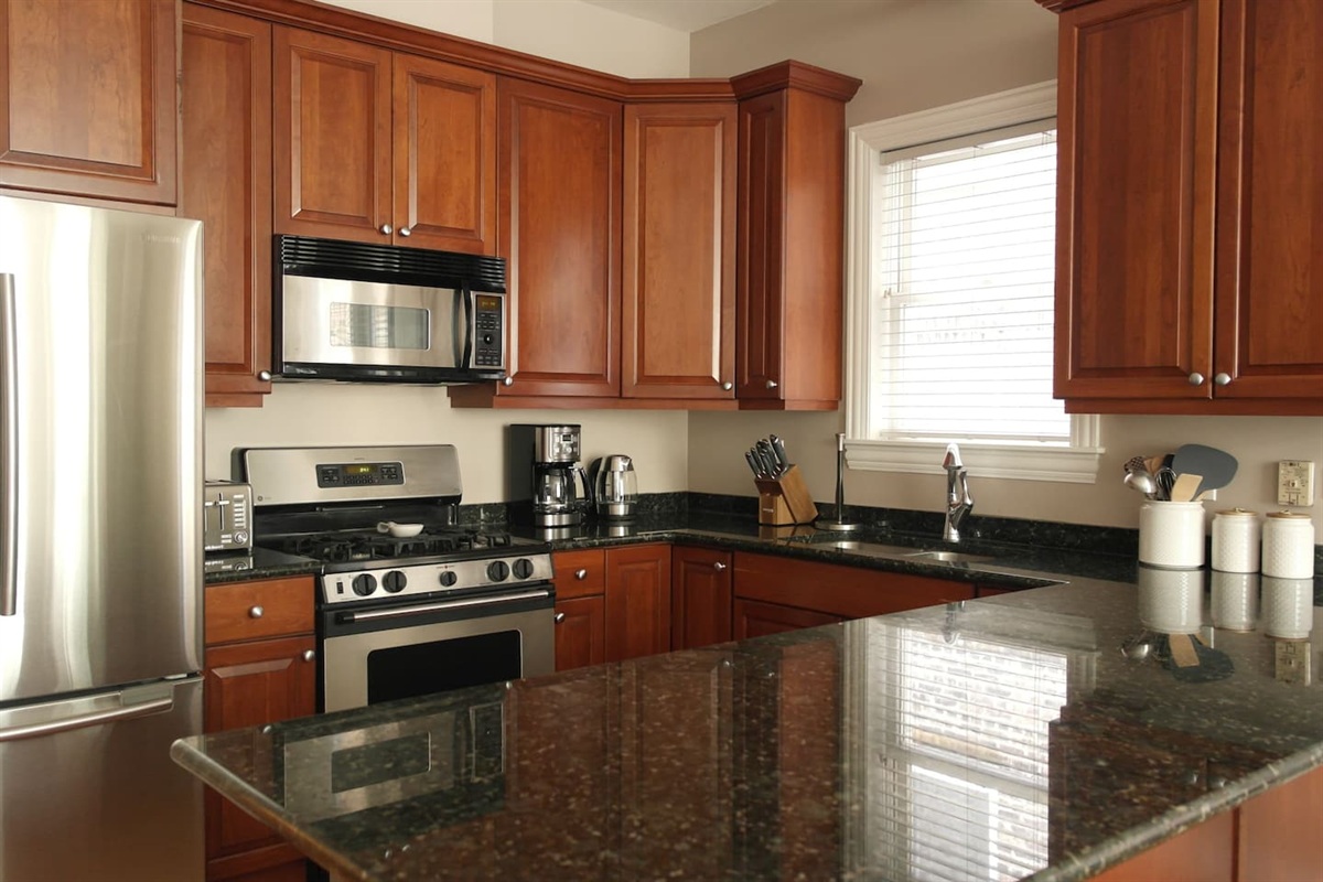 Kitchen fully stocked with cookware, dishes, and essentials