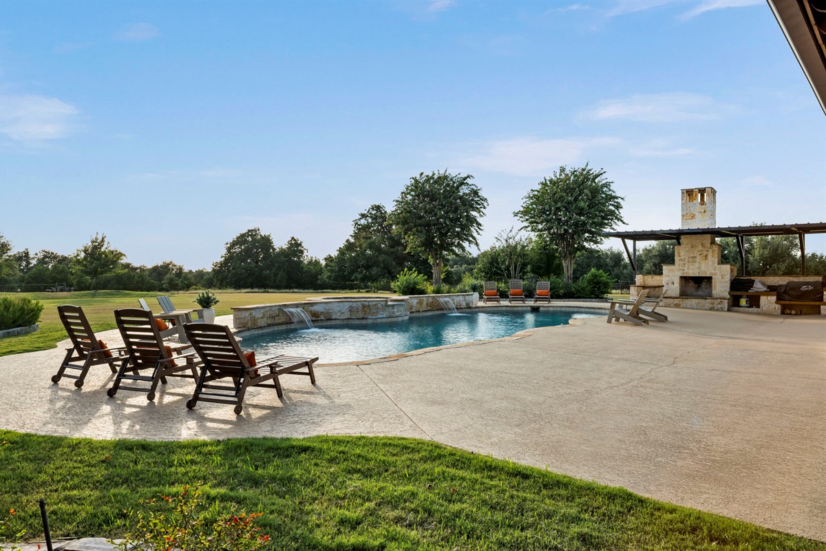Lounge chairs line the edge of a resort-style pool.