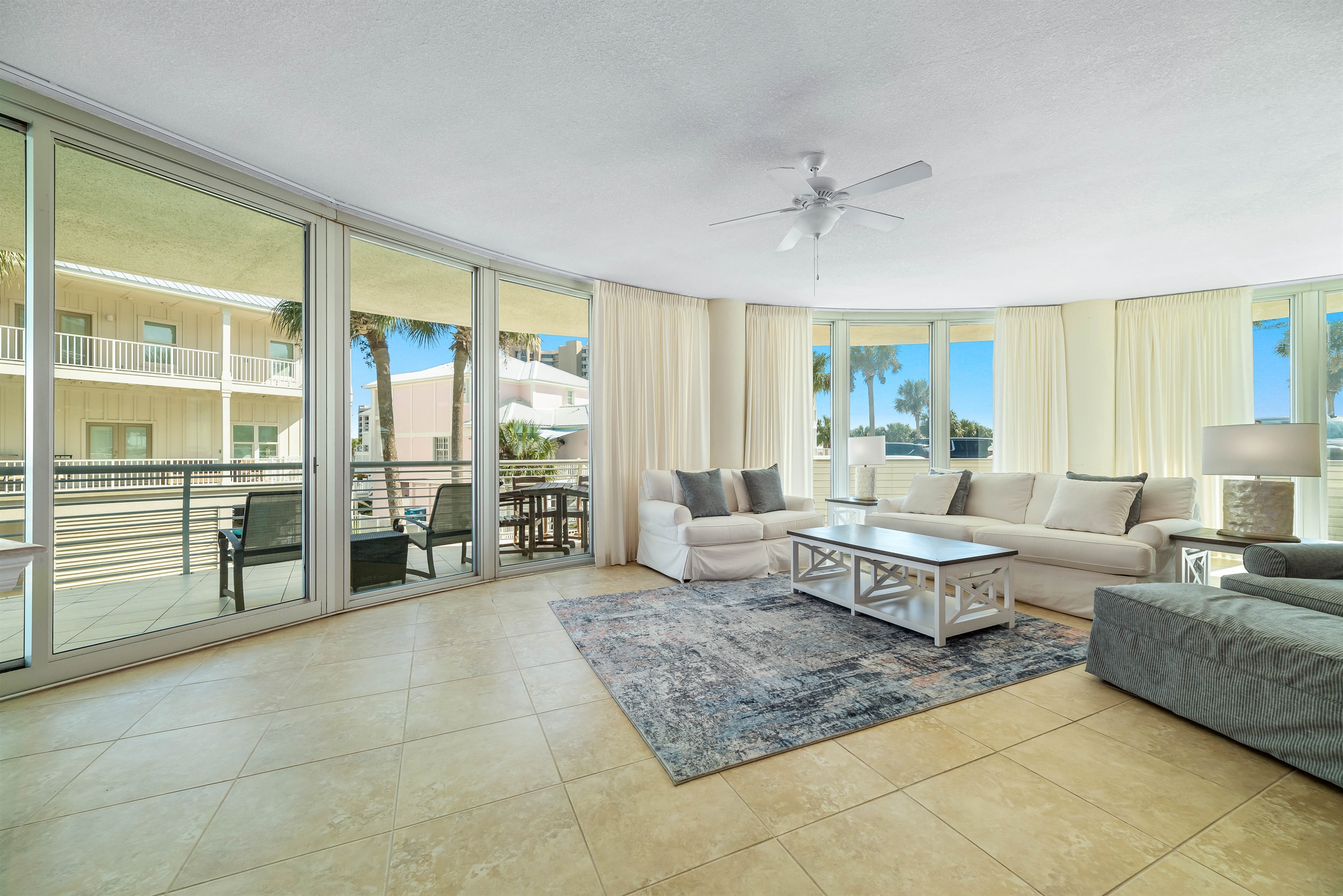 Spacious and inviting living area with floor-to-ceiling windows showcasing breathtaking panoramic views. This open-concept design seamlessly blends comfort and style, creating the perfect space for relaxation and entertainment.