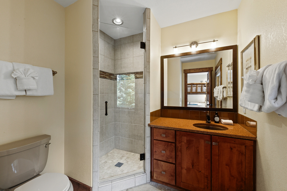 Upper level bedroom attached bathroom with shower and window (not seen in photo). 