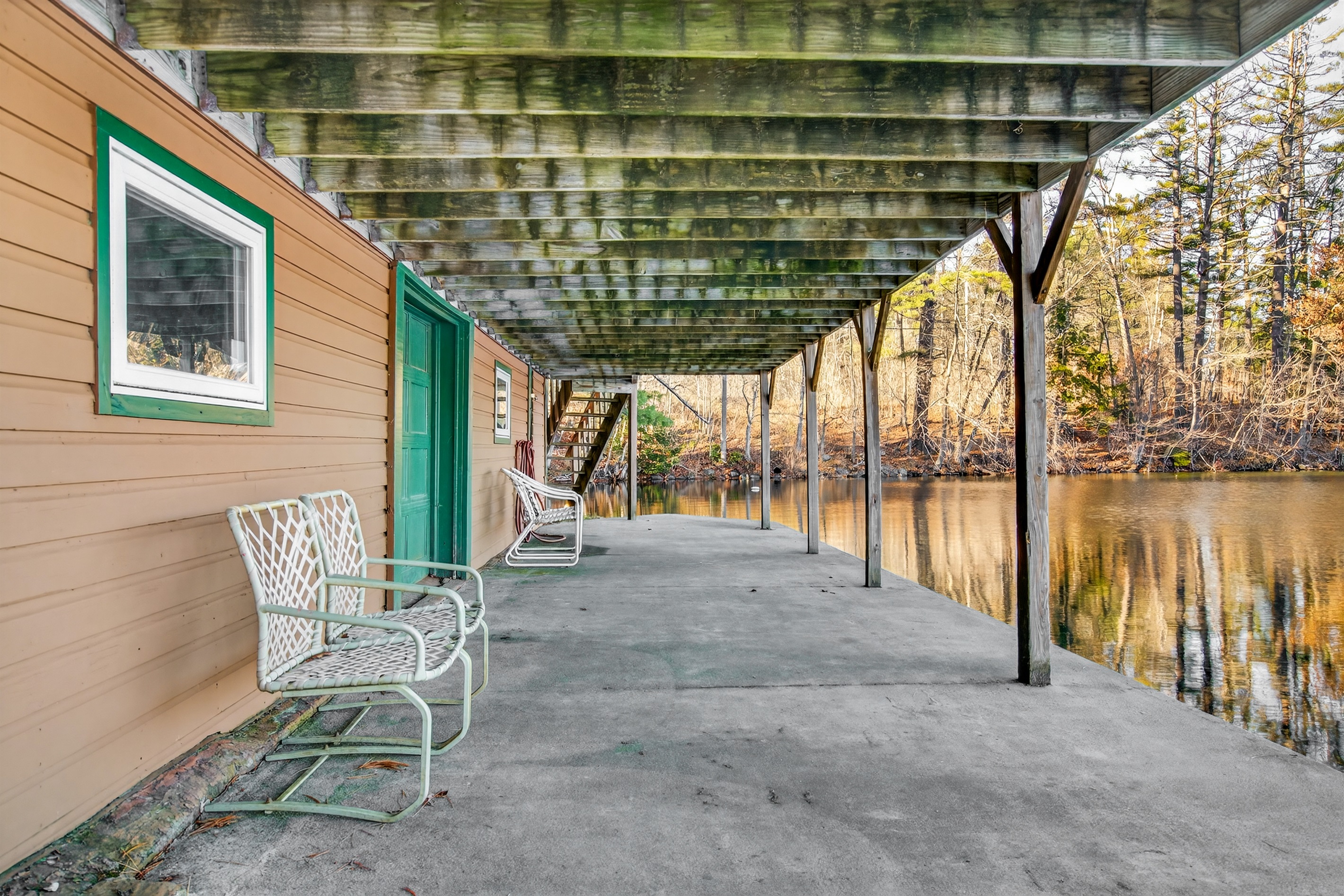 Front porch with comfy seating and peaceful lake views.