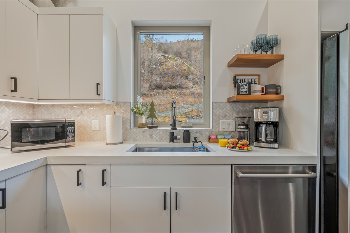 Fully loaded kitchen with 12-cup drip coffee maker with local ground coffee and tea provided