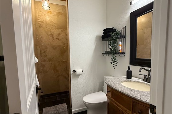 Mountain-lodge shower - slate  travertine shower, vanity with deep drawers for bathroom items shelves for convenience and comfort height for those sore quads. 
