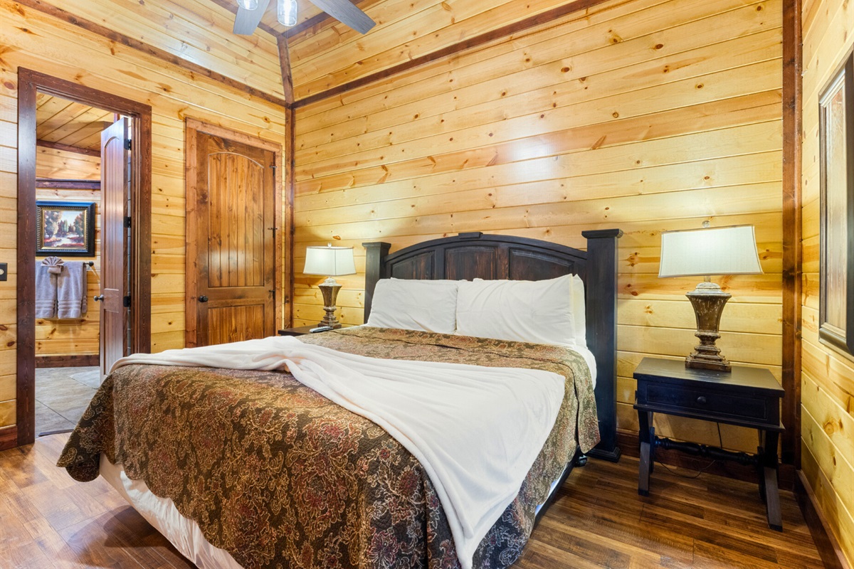 Warm wood walls, comfortable bedding, and rustic charm in every detail.