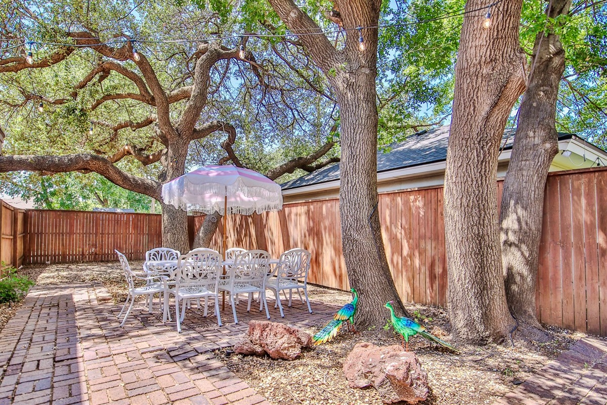 With string lights overhead and peacocks on parade, this courtyard with seating for 8, is fit for a feast and full of charm.