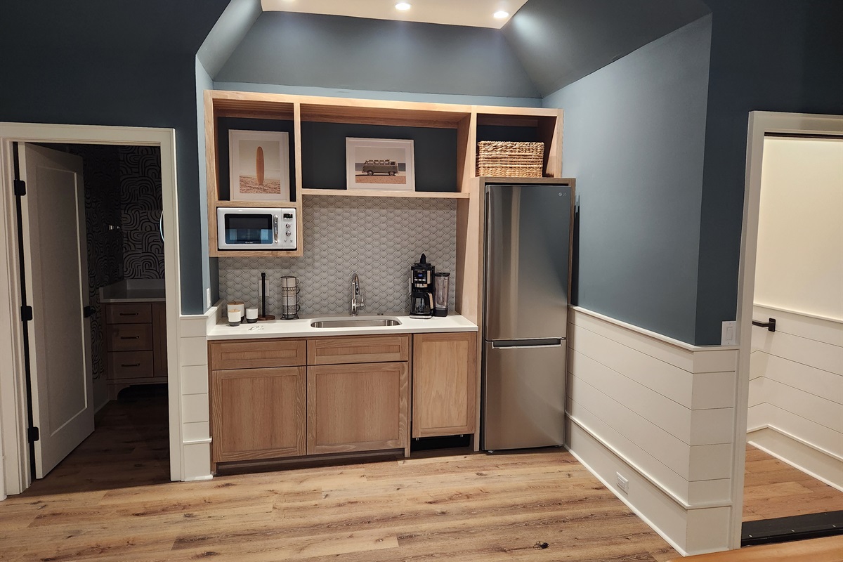 Suite over garage features a coffee bar with medium fridge