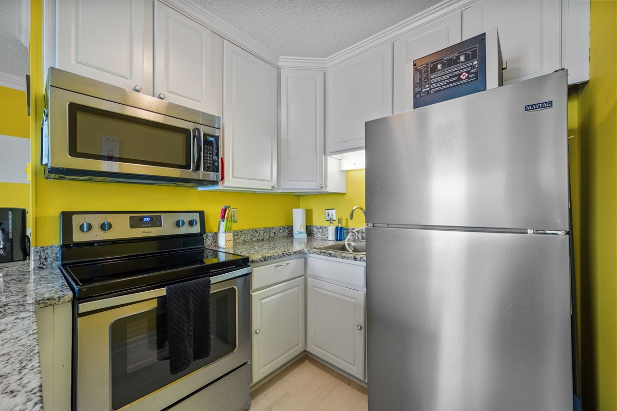Compact, fully equipped kitchen with modern appliances and everything needed for easy meals after a day at the beach