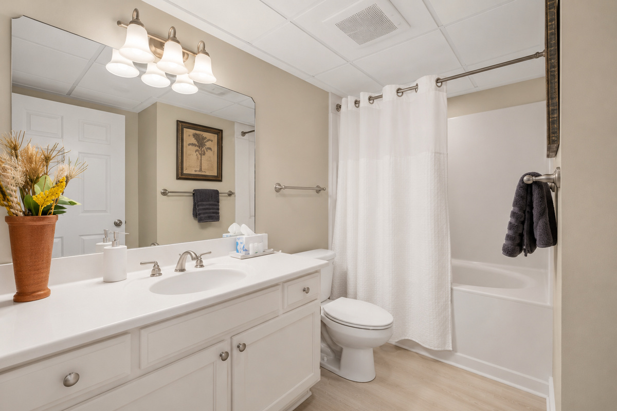 Second full bathroom with shower, vanity, and bathtub.