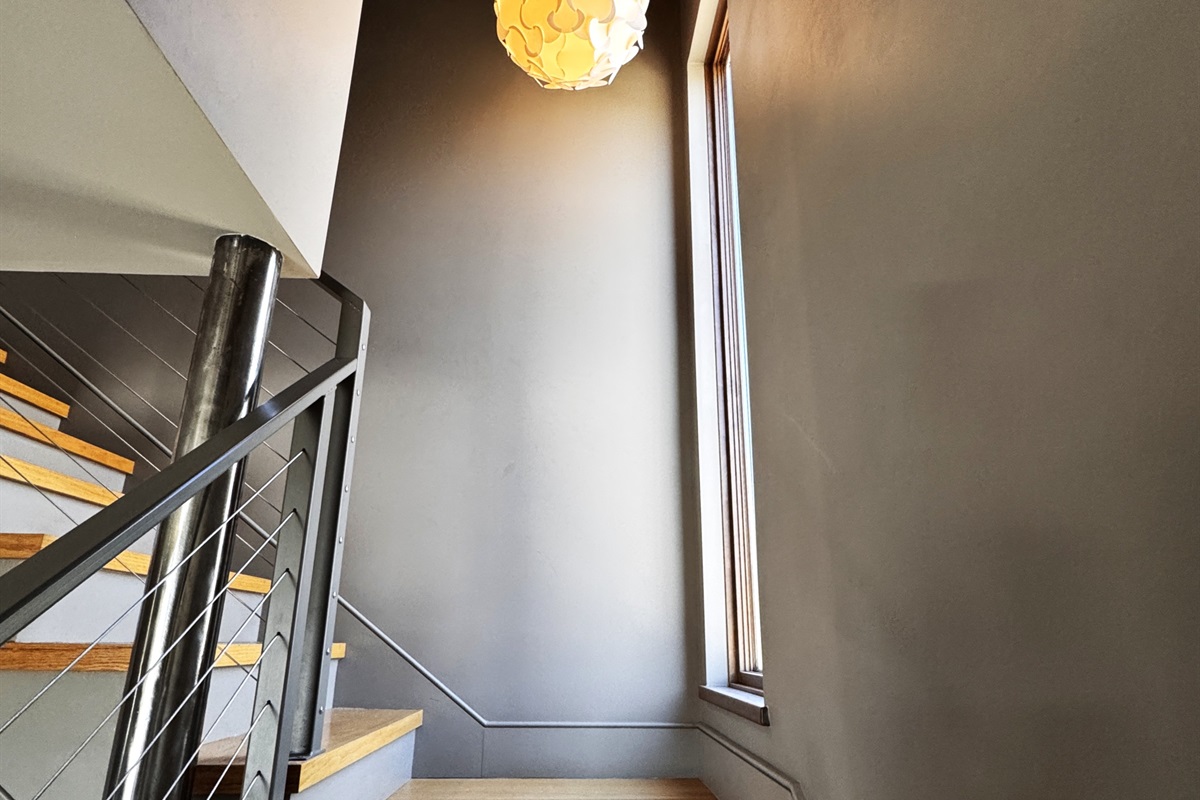 Ascend the Sky Passage to the third-floor loft. With its architectural cable railings and bold zebra-print risers, this Instagrammable transition feels like something out of a storybook, leading you to the highest point of our Mount Desert Island sanctuary