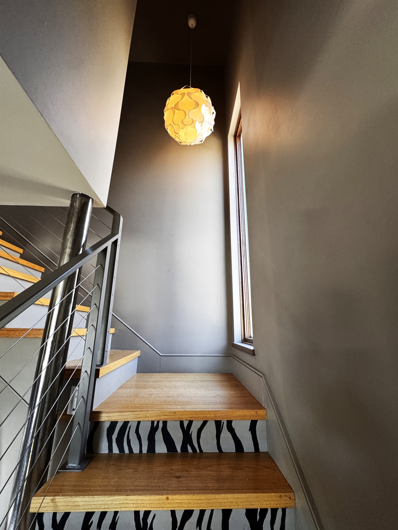 Ascend the Sky Passage to the third-floor loft. With its architectural cable railings and bold zebra-print risers, this Instagrammable transition feels like something out of a storybook, leading you to the highest point of our Mount Desert Island sanctuary