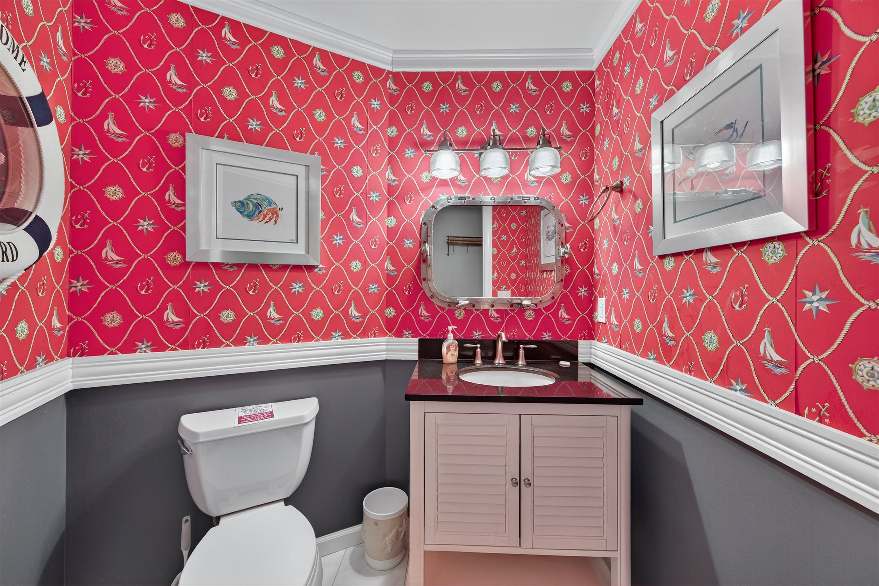 Fun and vibrant nautical-themed powder room full of character.