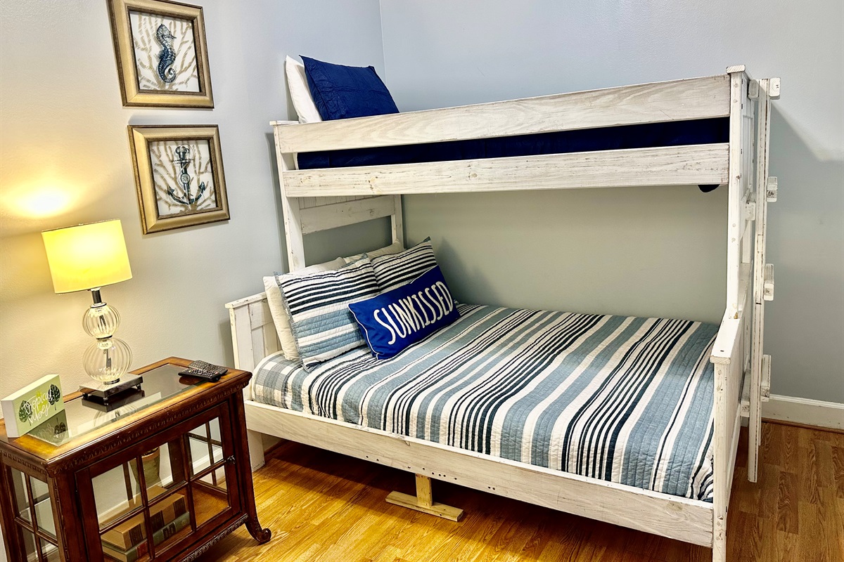 The guest bedroom maximizes space for the kiddos! There's a bunk bed with a full mattress on bottom, and twin on top!