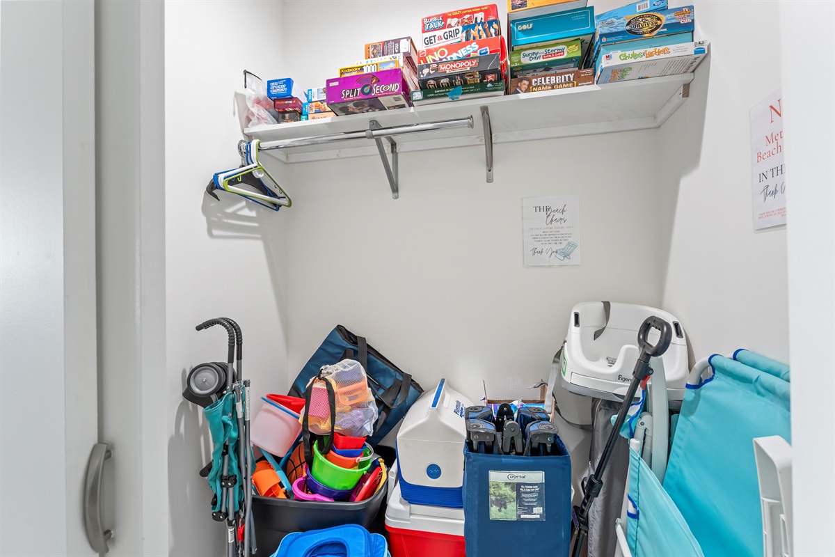 Living room closet has board games, puzzles, and additional beach gear
