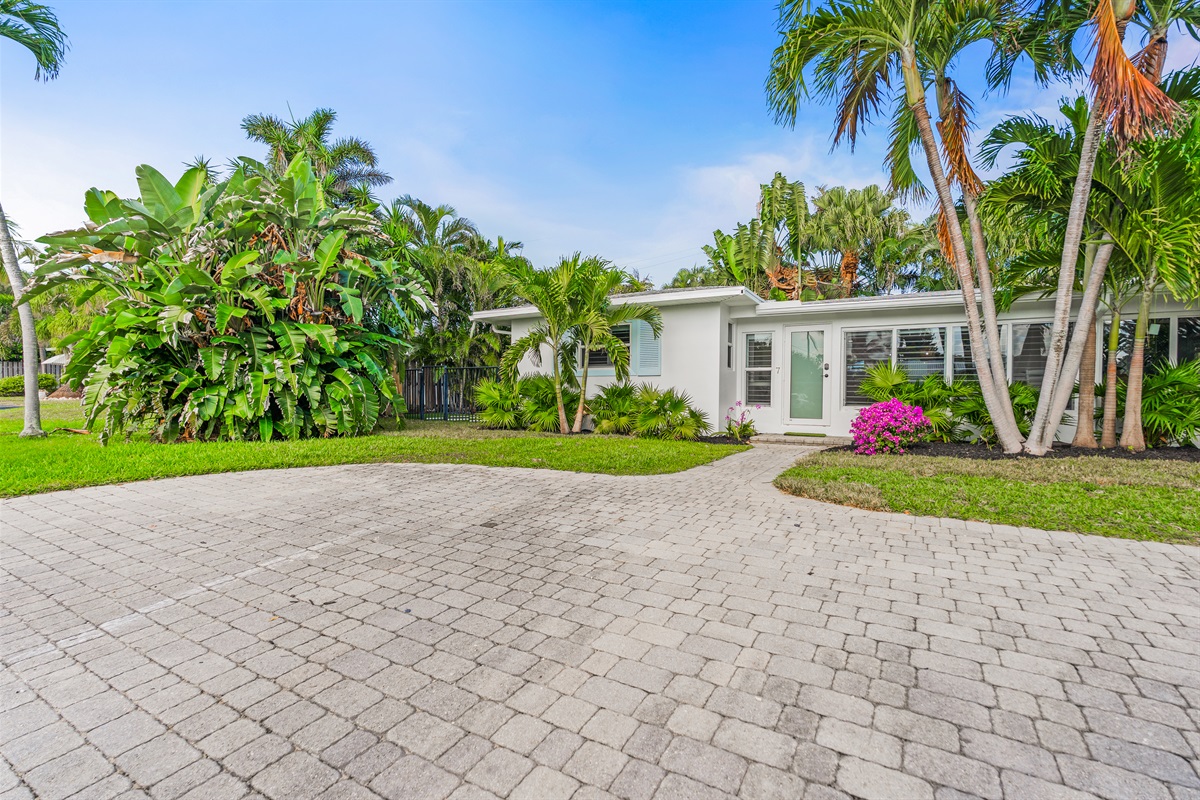 Ample private parking and a grand entrance under the Florida sun.