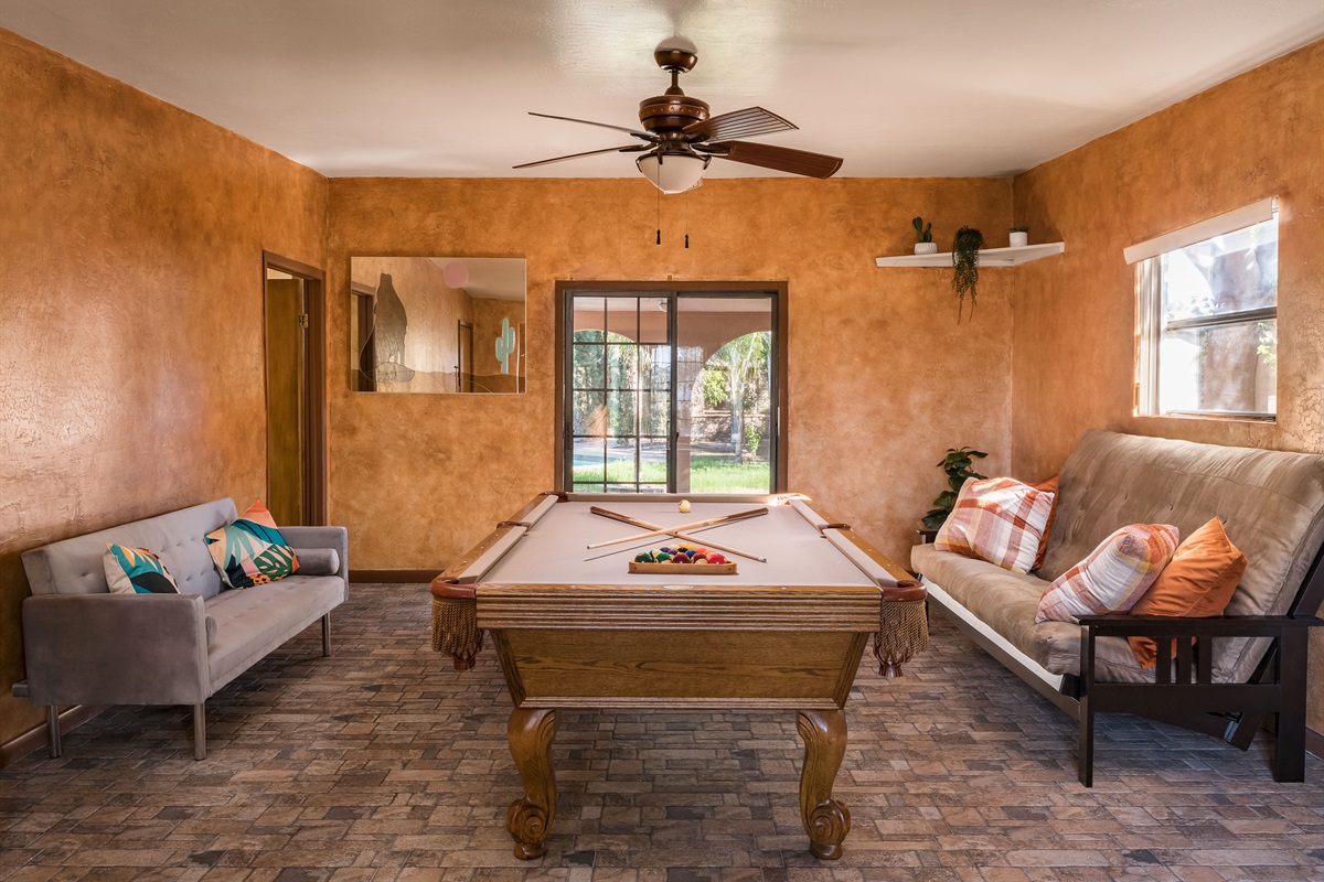 This vibrant game room features a full-size pool table, cozy lounge seating, and warm Southwestern charm for hours of laid-back entertainment.