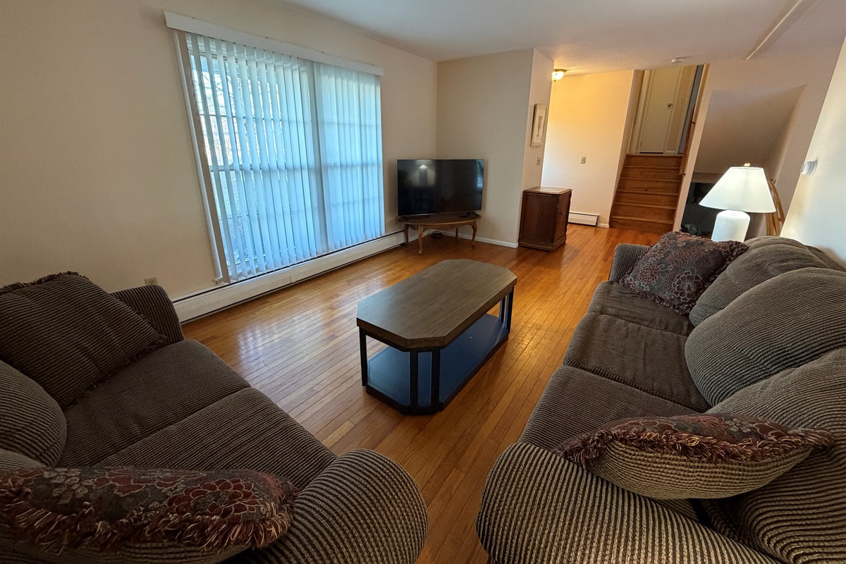 Living area with stairs up and down in background