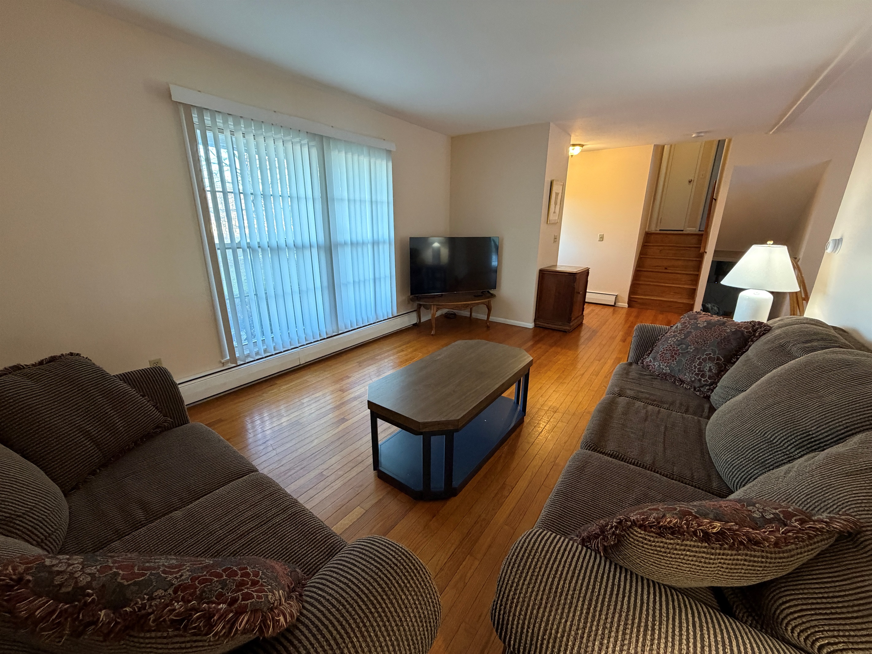 Living area with stairs up and down in background