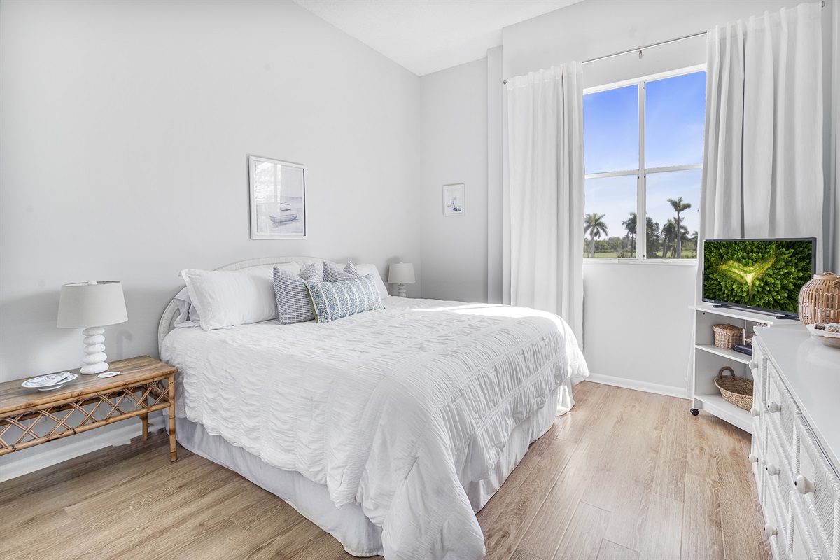 Relax in the serene comfort of the main bedroom, featuring plush bedding, peaceful views, and a private en-suite bathroom for added convenience and privacy.