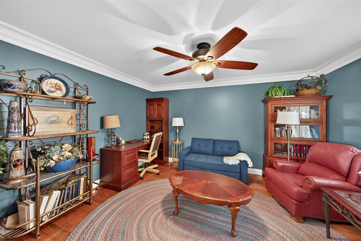 Bright flex room with a pullout sofa, perfect as an office or extra guest space.