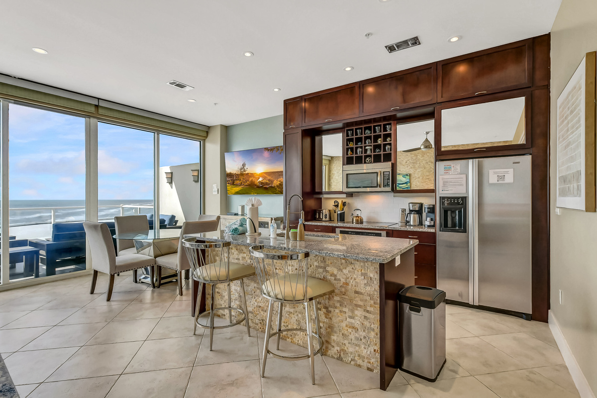 Large 200 sq-ft living area with sleeper sofa, indoor dining, and fully-equipped kitchen with island and granite countertops.  The indoor dining is perfect for bad weather.  Enjoy your favorite sports or shows on our 75-inch smart TV!