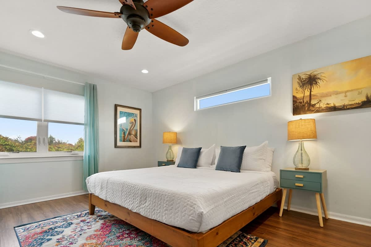 Another king bedroom upstairs, ceiling fan turning, everything calm and uncluttered. Three of the four bedrooms have a king bed, so nobody has to draw straws over who gets the good room this time around.