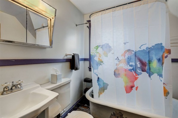 Enjoy the rustic wrought iron tub in this classic farmhouse!