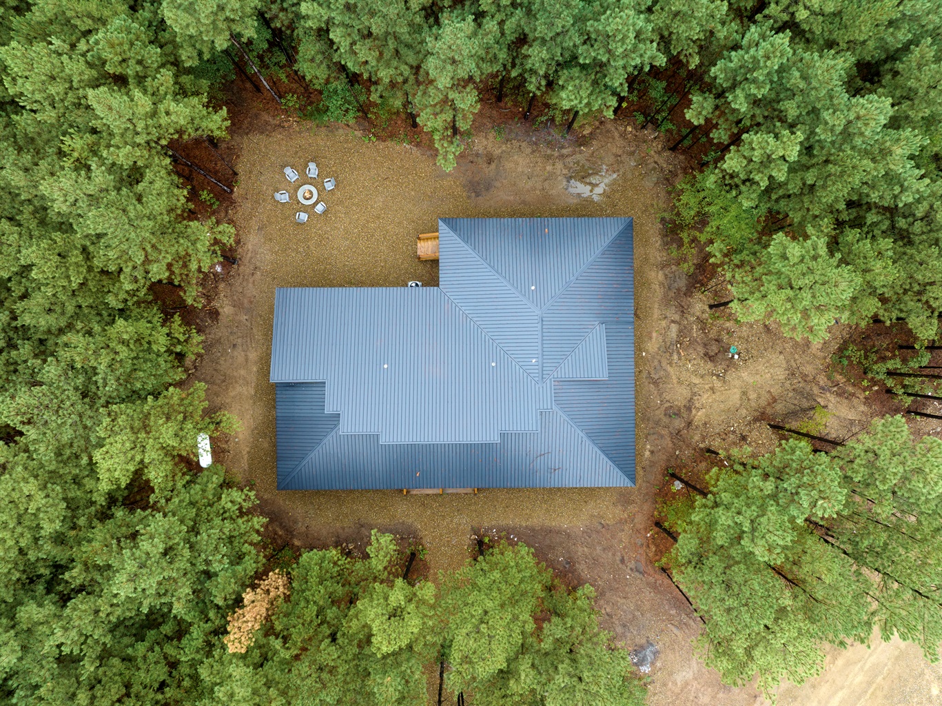 Nestled under beautiful tall pines. 
