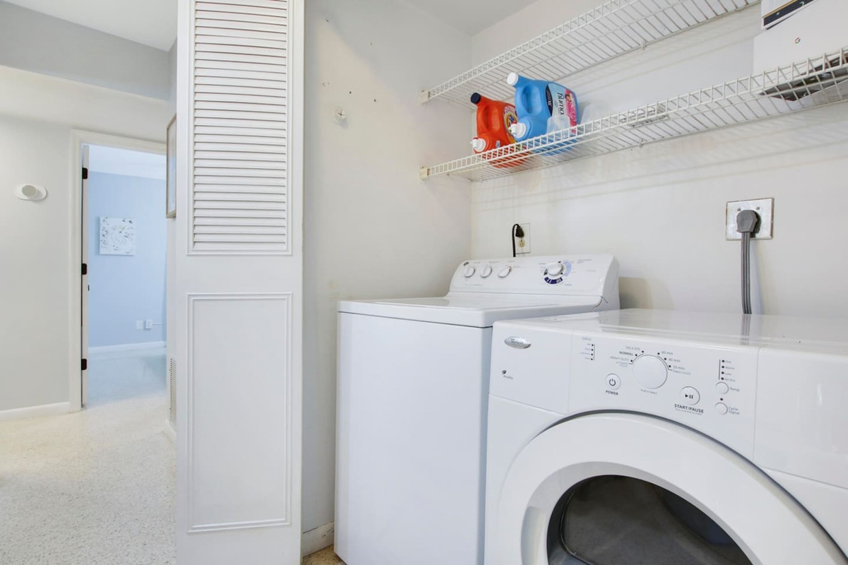 Laundry closet with washer / dryer.