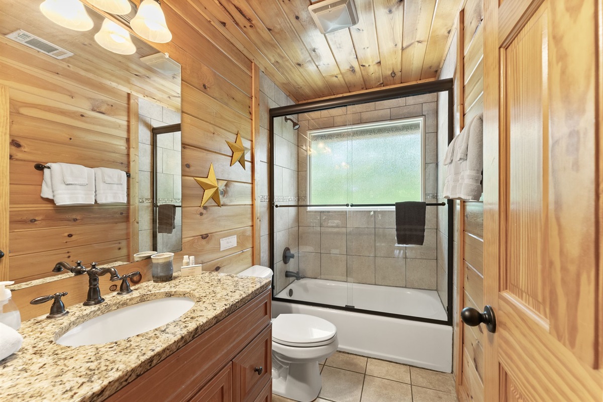 Private upstairs bathroom featuring a convenient shower and tub combo for comfort and relaxation.