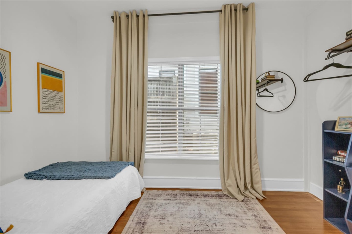 This room can comfortably sleep 2 people on this comfy twin trundle bed that pulls out into two twin sized beds with a mirror, hangers, and room darkening shades for added comfort and convenience. 