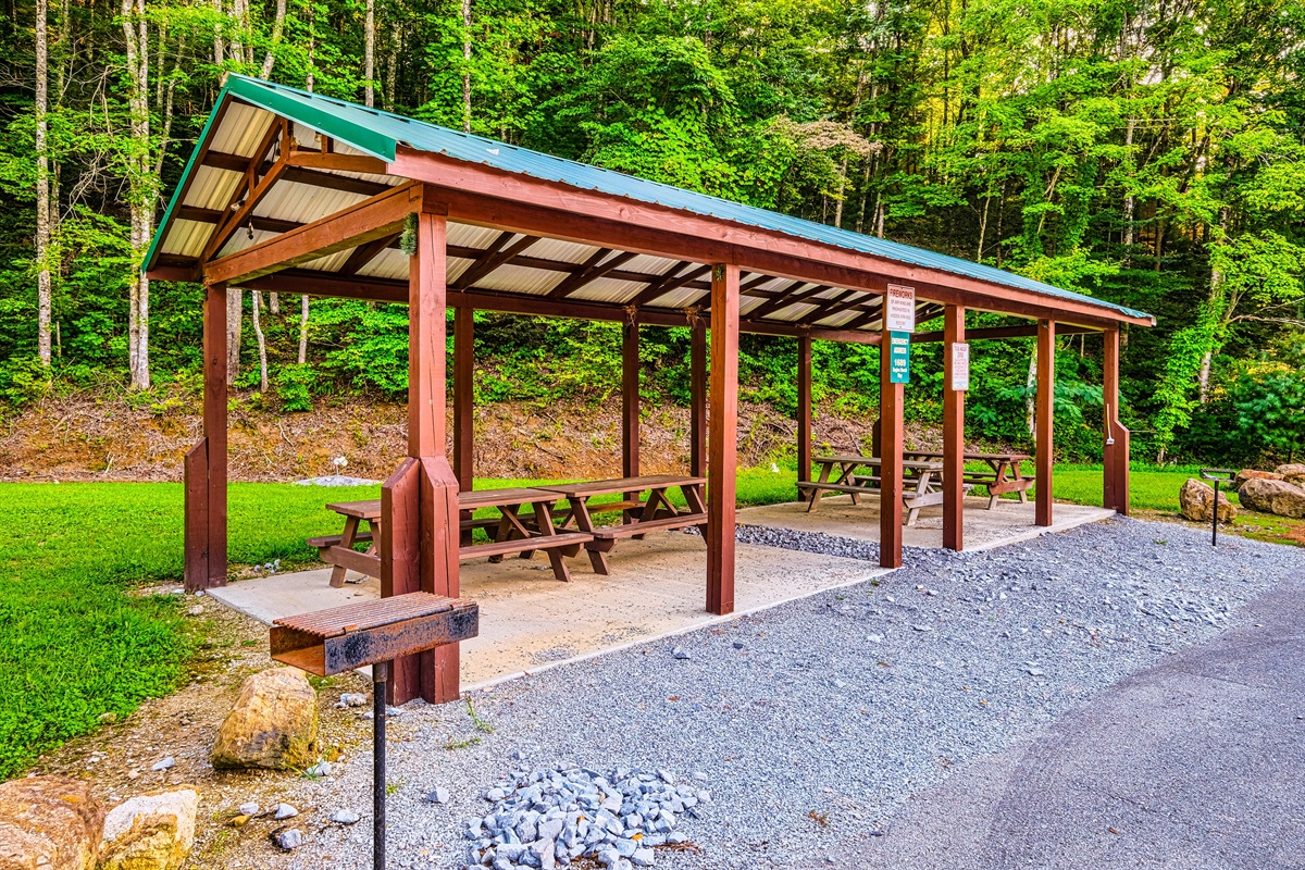 Picnic tables and BBQ by the resort pool