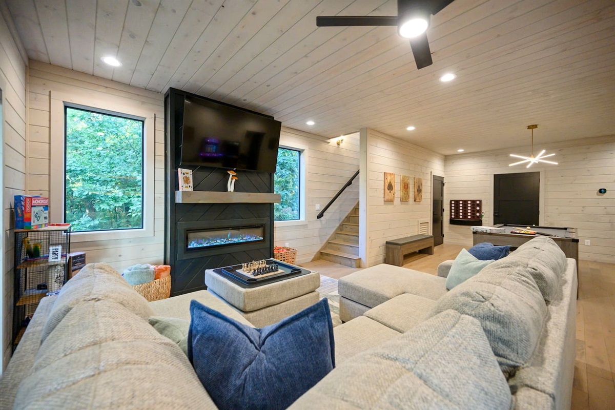 Game room features another fireplace and a 65" TV.