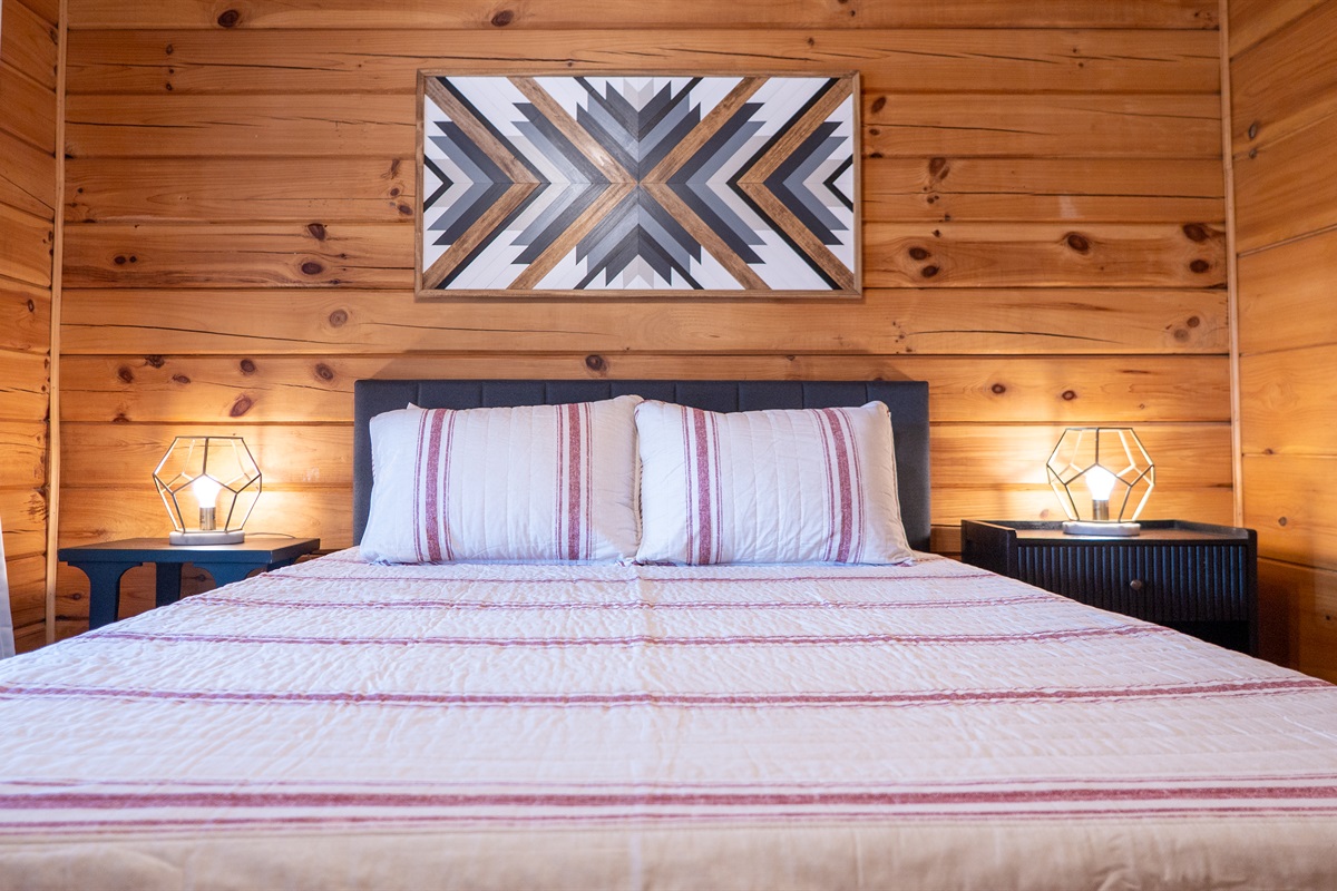 A peaceful retreat awaits in the main level bedroom, designed for a comfortable and private stay.