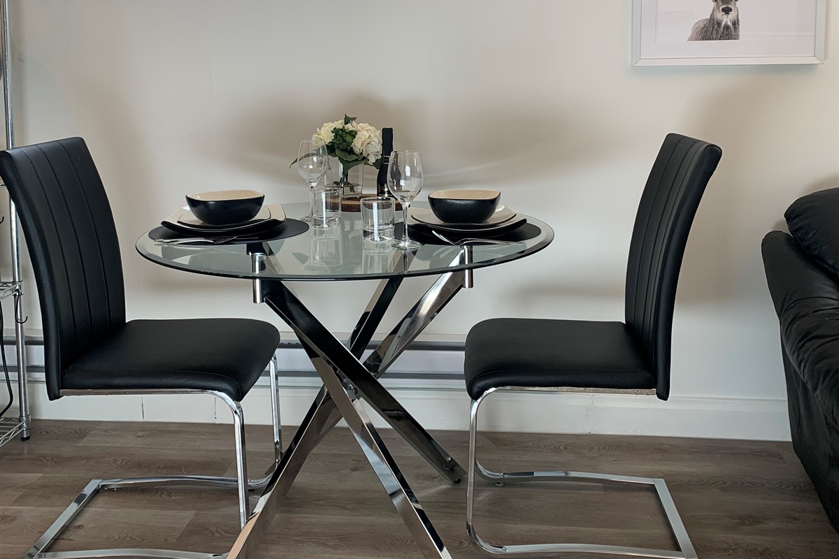 The perfect spot for a meal at home or late-night work session in this charming basement suite dining area.