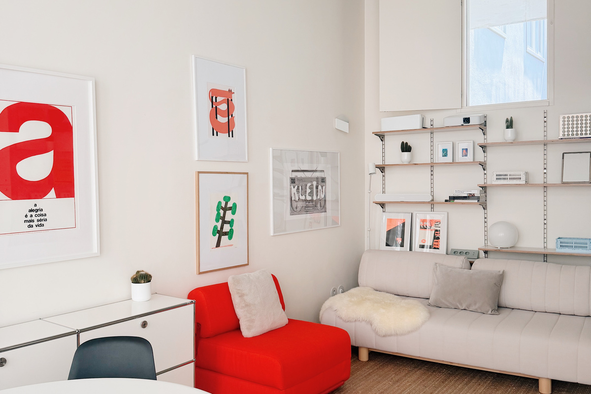 Red chair that opens into a single bed, and couch that also turns into a single bed.