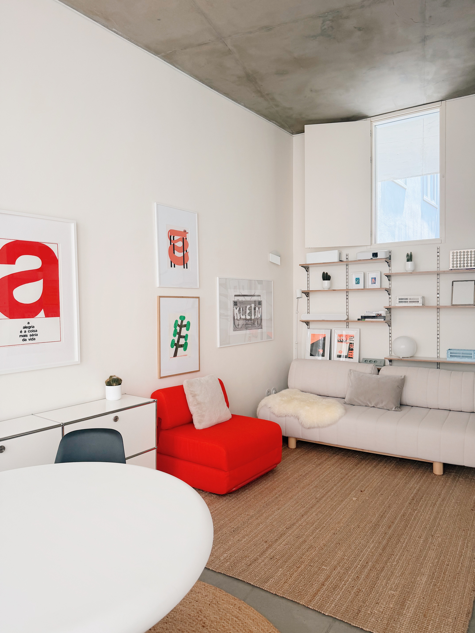 Red chair that opens into a single bed, and couch that also turns into a single bed.