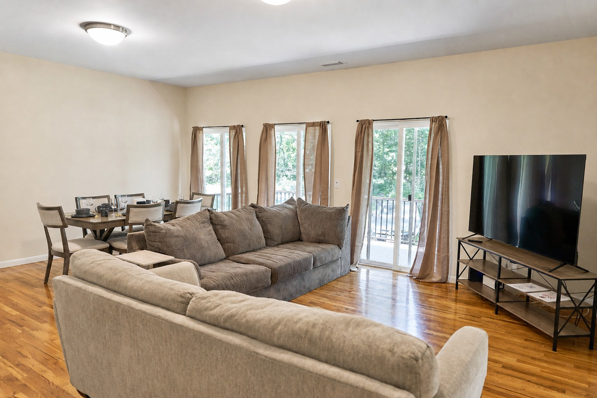 Living room with a sectional, a loveseat and a big-screen TV