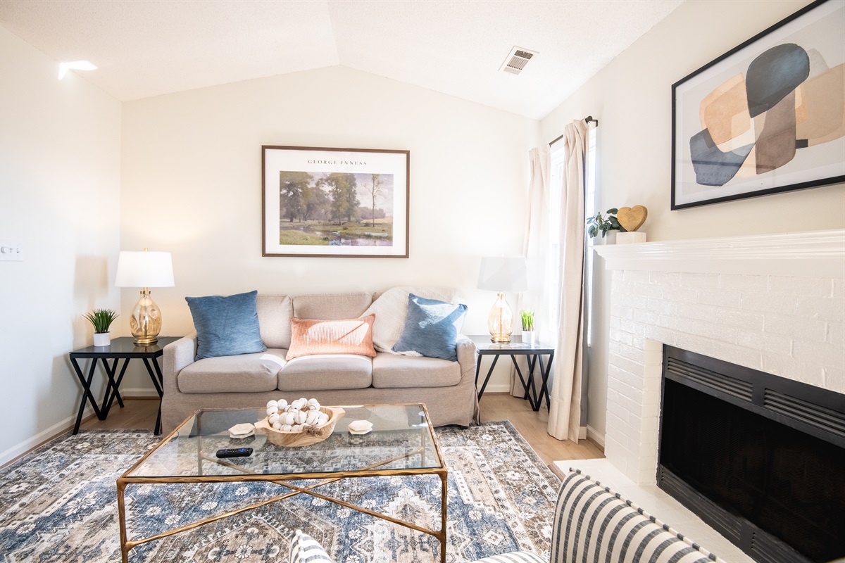 The living room is designed to present a calm gathering space made for conversation and connection