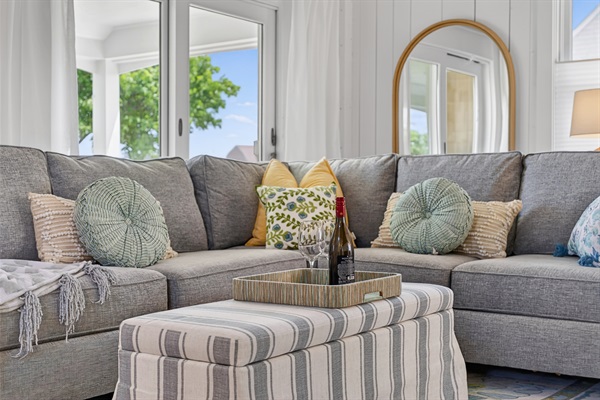 Bright and welcoming living room with comfortable seating and a cozy space to relax and unwind.
