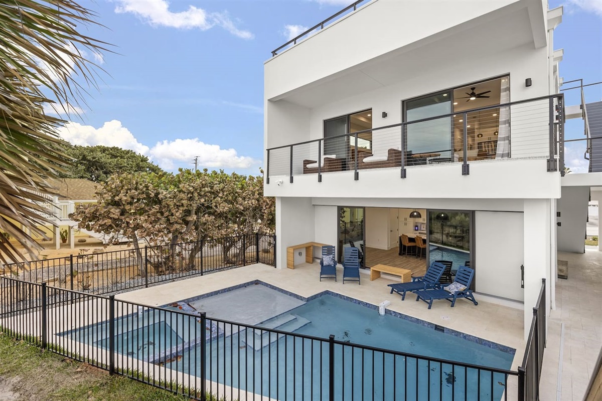 Relax by the beautifully designed pool, featuring modern contours and stylish details that create a serene and inviting atmosphere, perfect for lounging or taking a refreshing swim in a tranquil setting