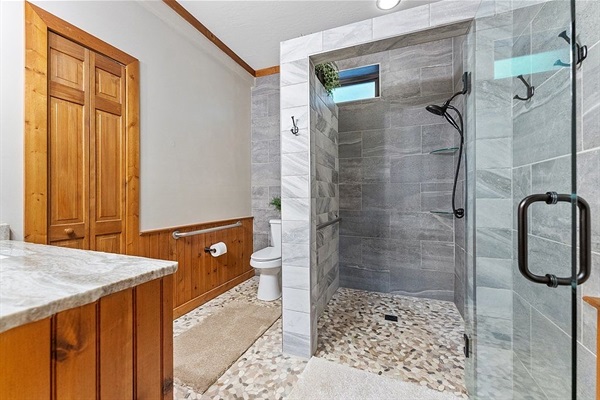 En suite bath w/ walk in shower, private to the king bedroom on the main level