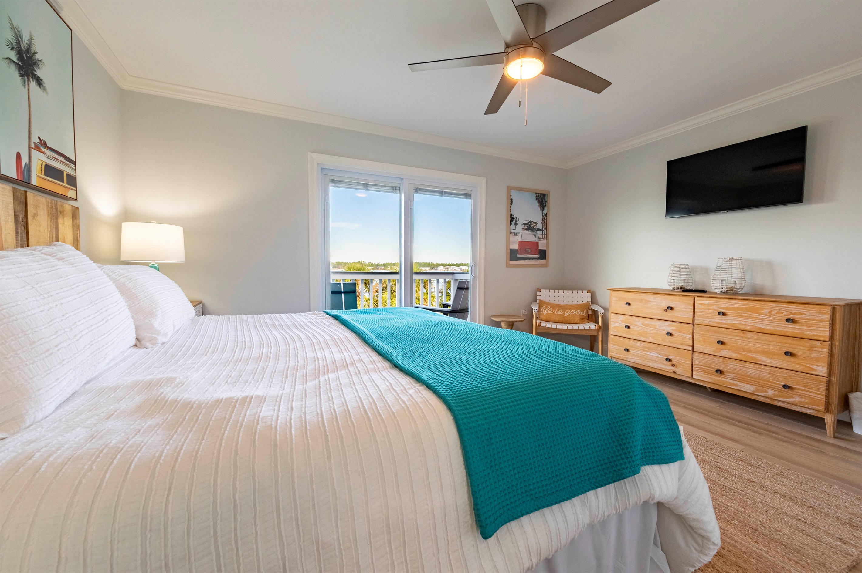 Bright bedroom escape: Ocean view, modern decor, and soothing natural light.