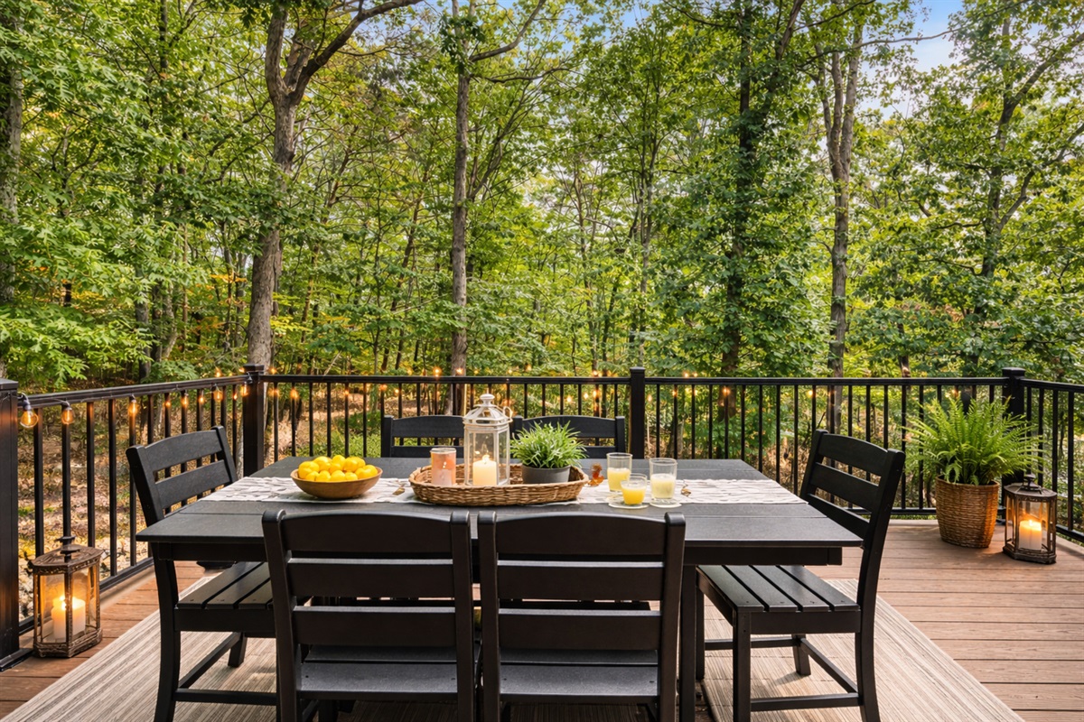 Morning coffee or evening dinner, the deck gives you a full canopy of trees and total quiet — the French doors open right from the dining room so you never have to carry far.