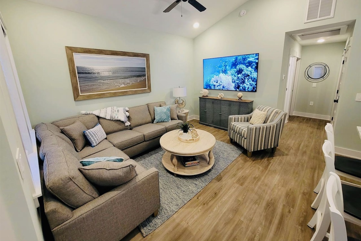 Large open living room with a 75 inch Smart TV.